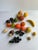 Lot of 20 alabaster and stone fruit, includes a mixture of apple, banana, peaches, tangerines, grapes, figs, walnut,...
