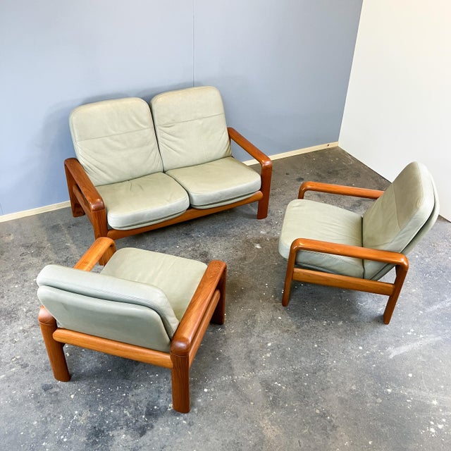 Elegant set consisting of a two-seater sofa and two armchairs, made in denmark by dyrlund. The exceptional design of the...