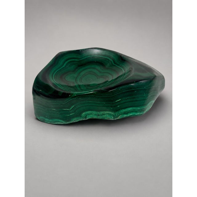 A striking pair of sculptural desk dishes carved from exceptionally decorative malachite, each fashioned as a low,...