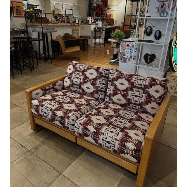 Reupholstered MCM Oak Loveseat and Chair Set. Reupholstered in an aztec print. LoveSeat: 52.5x32x28 Chair: 29x32x28