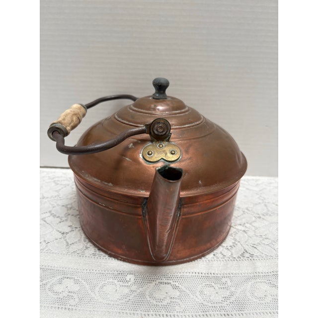 Large French farmhouse antique copper and brass kettle with rustic wood handle. Authentic, aged, weathered charm. The...