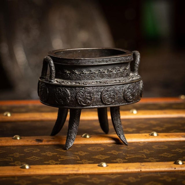 Antique 19th Century Japanese bronze vessel, Edo period. The vessel is raised on four tall feet and similarly cast with...