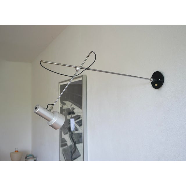 Early production Model 213 wall light designed by Gino Sarfatti in 1956. Italian minimalist elegance at is best. This lamp...