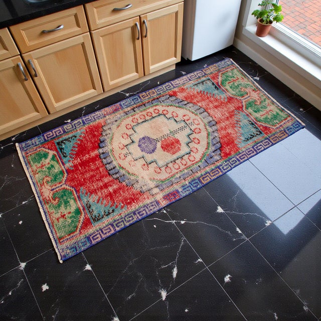This authentic 1980s Demirci rug from Central Anatolia showcases the honest craftsmanship of village weavers who created...