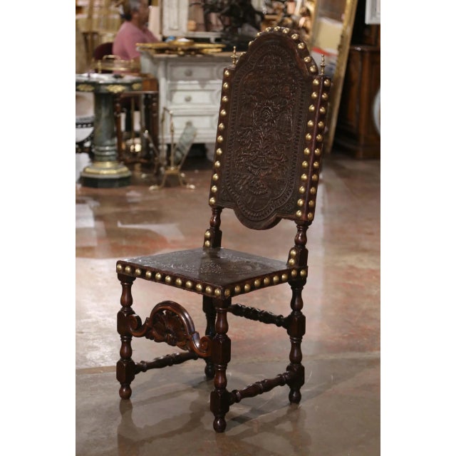 Richly decorated and impressive in scale, this antique Portuguese Renaissance chair combines intricate wood carving with...