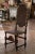Richly decorated and impressive in scale, this antique Portuguese Renaissance chair combines intricate wood carving with...
