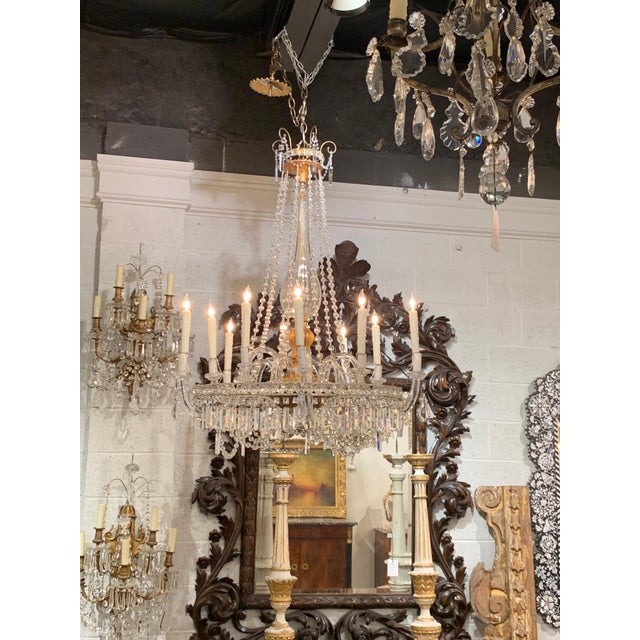 Elegant 19th century Italian giltwood and crystal chandelier with 10 lights. Pretty glass detail on the base and arms of...