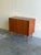Elegant Mid Century Modern Danish sideboard crafted in warm teak wood, featuring classic Scandinavian proportions and a...