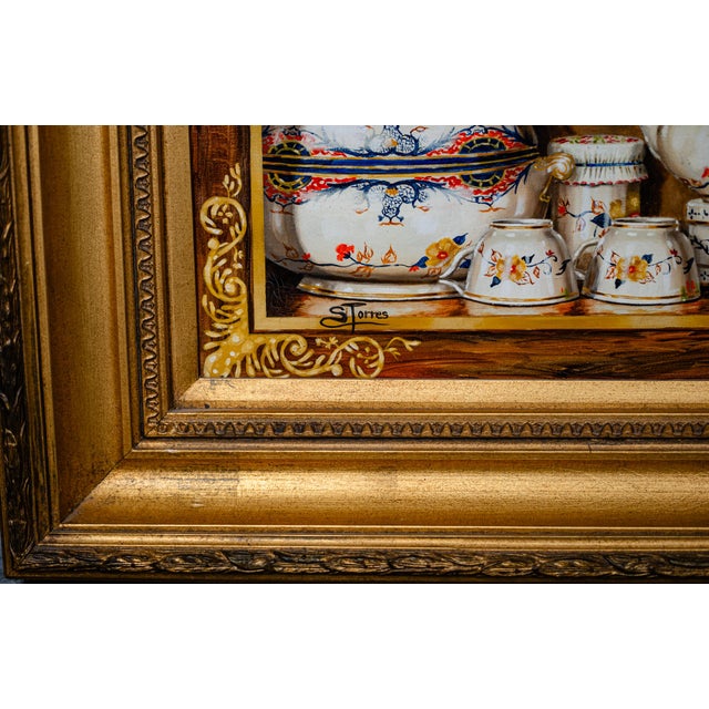 Amazing detail in this fabulous oil painting of tea sets on a shelf. This beautiful painting is framed in a thick Gilt...