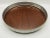 An open-work silver plate serving tray with a center panel made of Formica in a rich mahogany wood tone, perfect for...