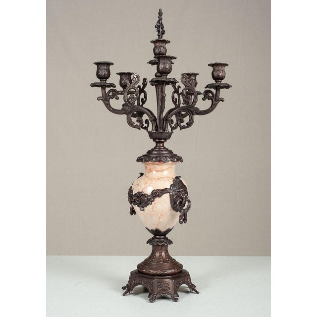 Handcrafted in Italy, this mantel clock garniture set features a central clock and matching pair of five-light candelabras...