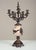 Handcrafted in Italy, this mantel clock garniture set features a central clock and matching pair of five-light candelabras...