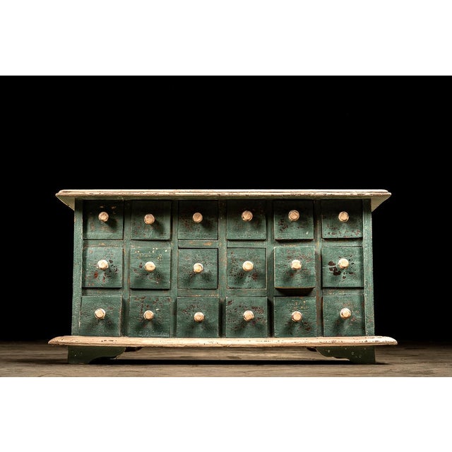 Primitive cabinet with pronounced molding likely manufactured around the turn of the century by a craftsman for use in...