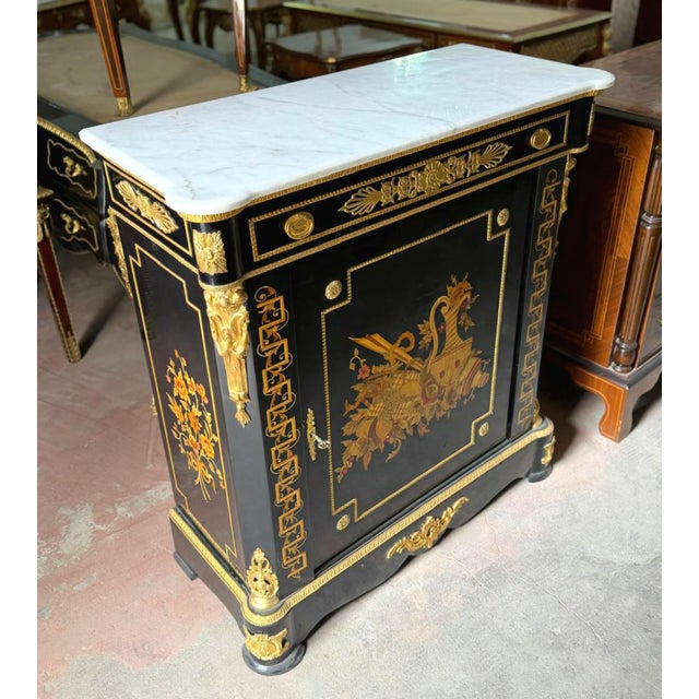 Make a sophisticated statement with this French Louis XVI-inspired commode, featuring a rich black wood finish, elegant...