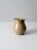 This is a studio pottery creamer. The hand-crafted pitcher features a beautiful tan glaze. Classic shape with beautiful tone.