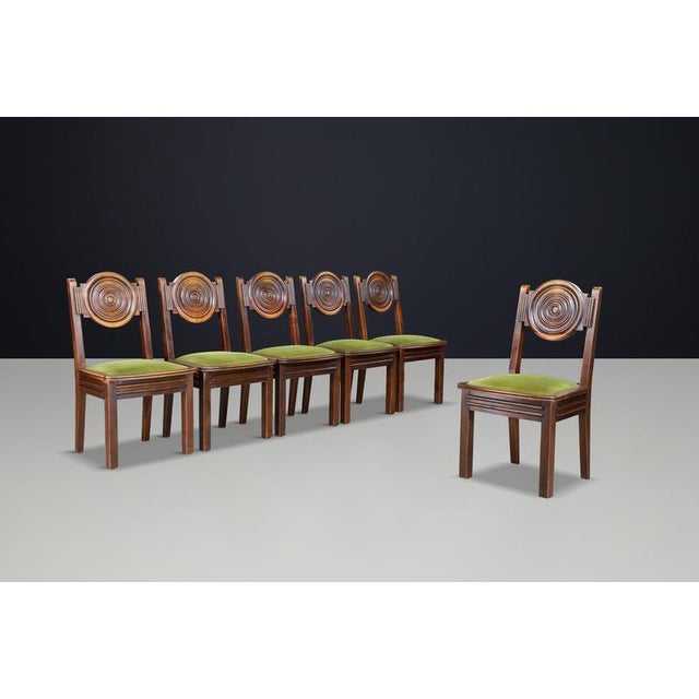Beautiful set of six carved oak dining chairs by Charles Dudouyt, featuring sculptural circular backs, patinated oak...