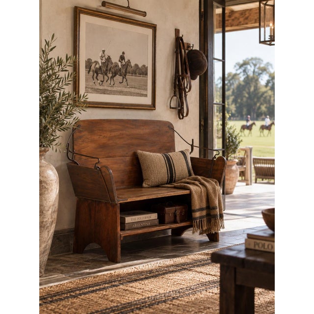An antique buggy seat bench with a beautifully shaped wood seat, tall back, and sweeping iron supports retained from its...
