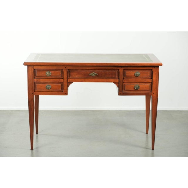 Elegant English-style desk with a green leather top featuring beautiful gold-colored details and five drawers. : This...