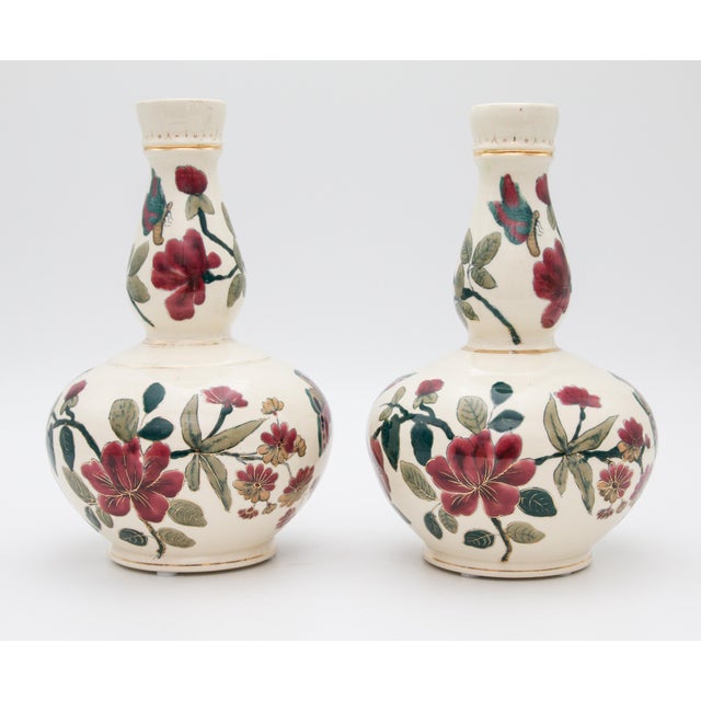 A gorgeous pair of early 20th-Century Italian faience double gourd vases. These lovely vases are hand painted with finely...