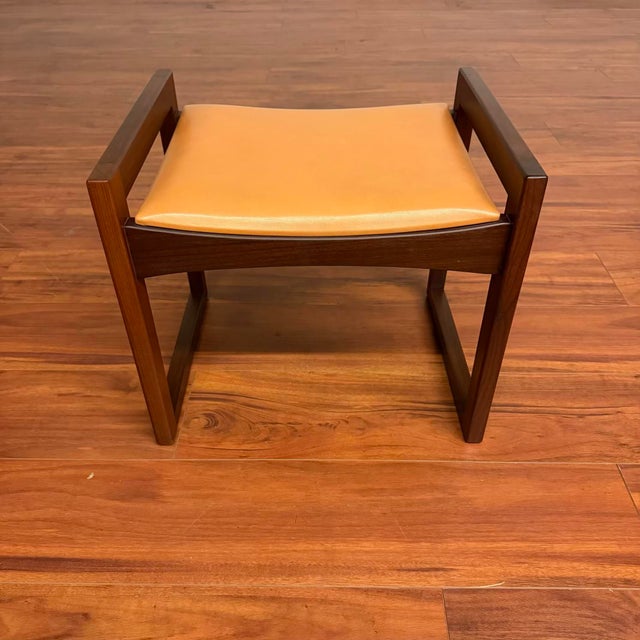 Beautiful vintage mid-century stool / ottoman made in the U.K. circa 1960's. It features a boxed leg afromosia (African...