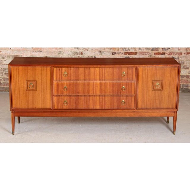 Mid Century teak and tola sideboard by Greaves&Thomas for Heal's, circa 1960s. Brass handles and brass capped feet....