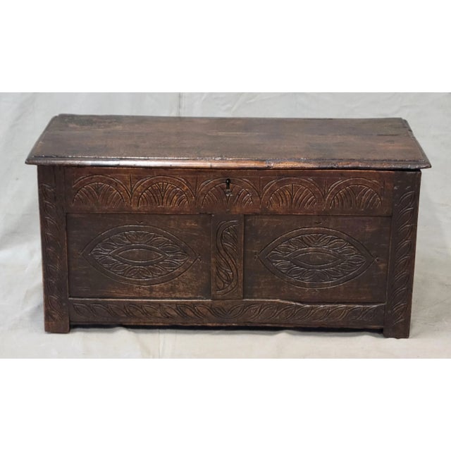A beautiful, classic 19th century English carved oak storage trunk or coffer. Incised decorative carved patterns in the...
