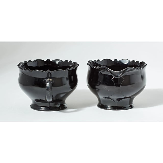 High quality black glass sugar and creamer set. Minor wear is visible. No chips in the glass.