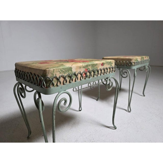 Charming pair of Italian stools dating from the 1950s, featuring decorative wrought iron frames with elegant scrolling...