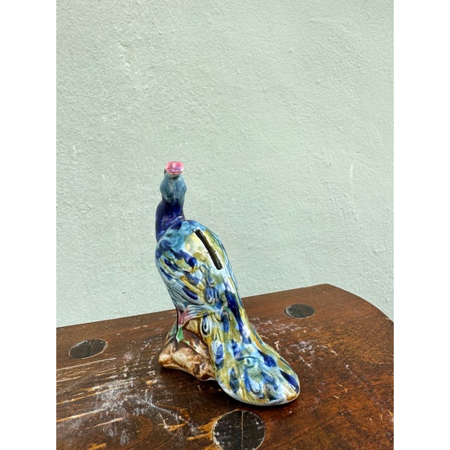 A charming hand-painted ceramic peacock figurine most likely from Stangl Pottery. Rendered in vivid cobalt blue with...