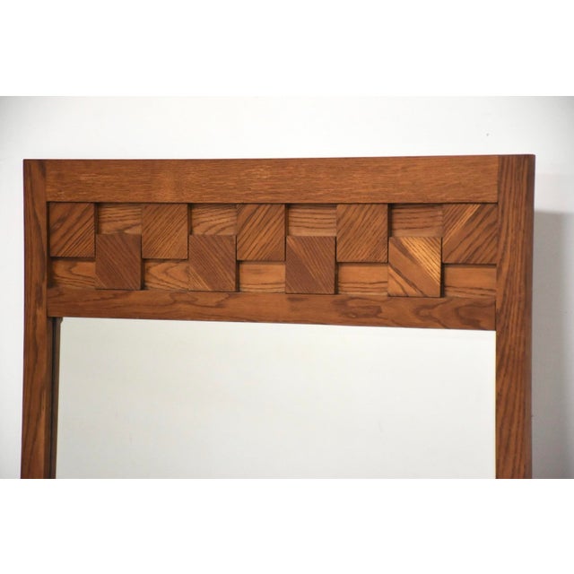 A mid century modern golden oak Brutalist chunk block mirror.