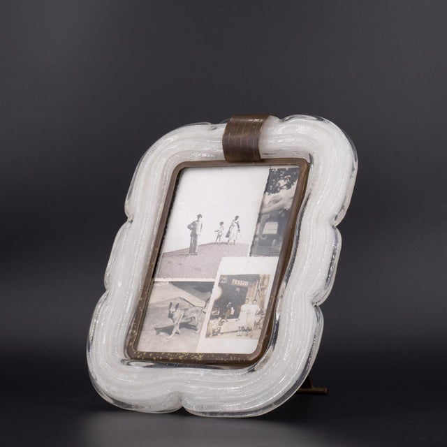 1940s photo frame. Made in Italy in Murano glass. Brass frame. Designed by A. Seguso. In good overall condition, with...