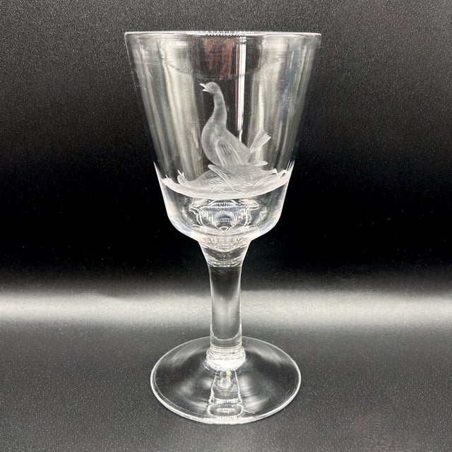 An elegant trio of antique English hand-blown glass wine goblets (20 cm high) featuring a detailed wheel-engraved frieze...
