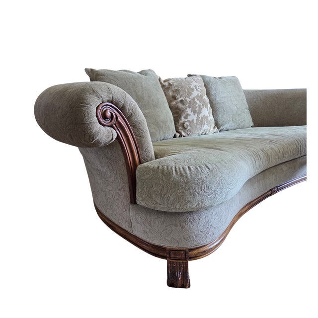 A Bernhardt curved sofa, upholstered in a neutral jacquard fabric with subtle light green undertones. Features a carved...