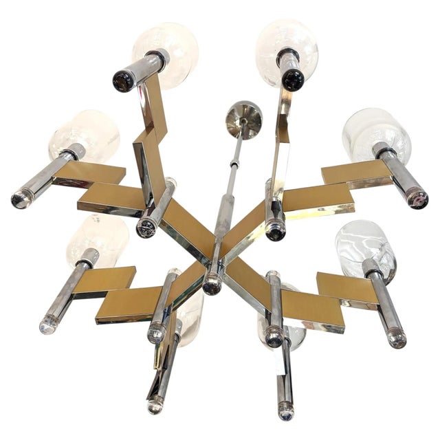 Italian Mid-Century Gaetano Sciolari chandelier is made of chrome and satin brass metal with clear glass elements-shades....