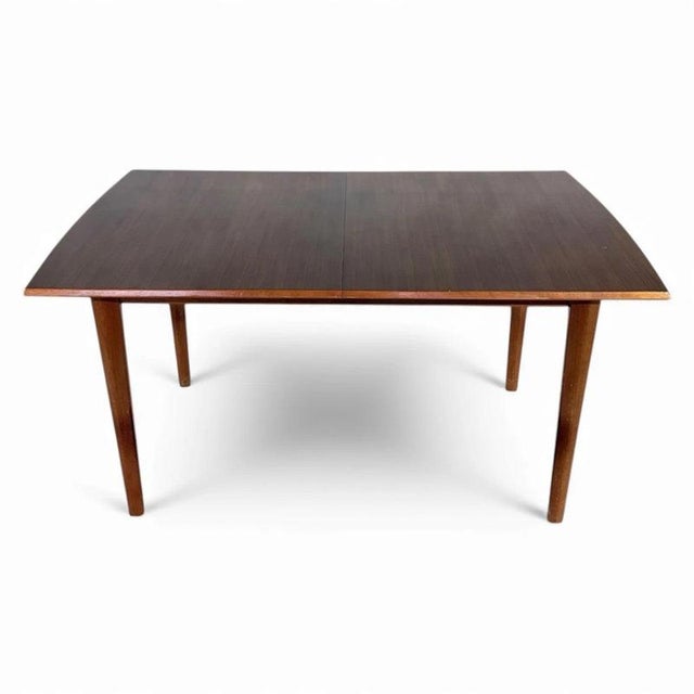 This mid century dining table by Alfred Cox is a versatile dining table designed to bring both style and function to your...