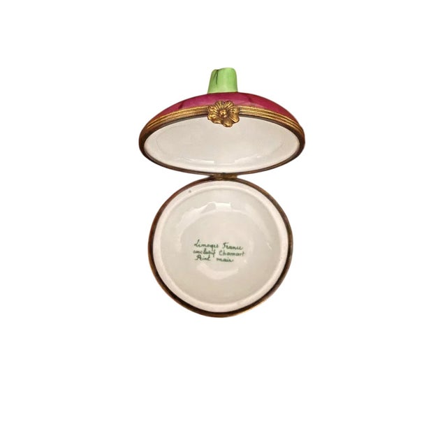 A charming and finely detailed hand-painted Limoges porcelain trinket box in the form of a turnip, executed with soft...