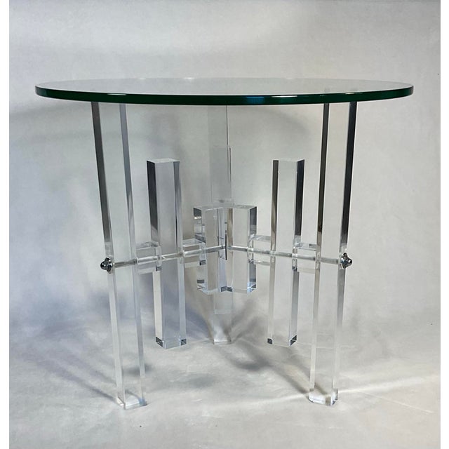 Glamorous 1970’s Mid-Century Modern Lucite columns and glass round side table. This table features chrome accents, a...