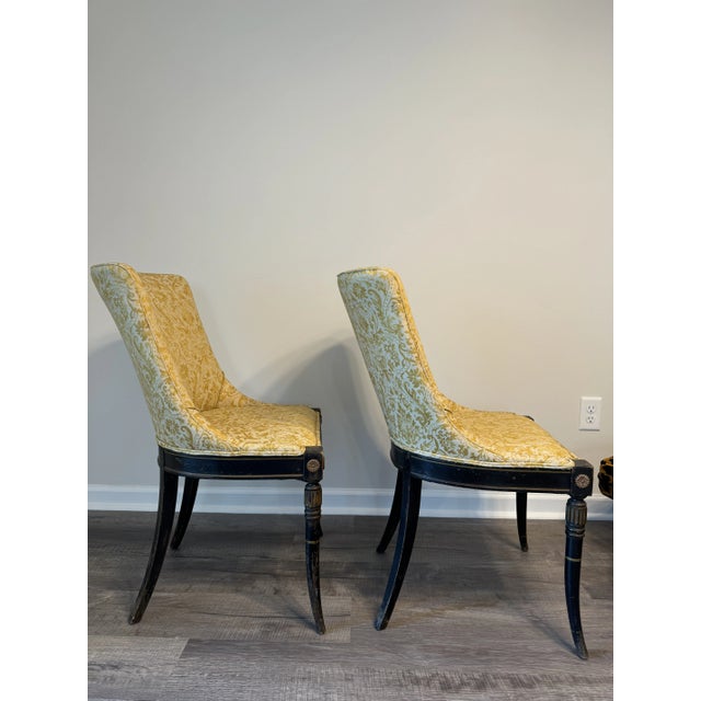 A lovely pair of neoclassical Sabre leg side chairs with barrel back upholstered in a yellow and tan Fortuny style fabric....