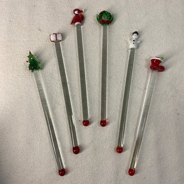 These items are vintage hand-blown lampwork glass Christmas swizzle sticks, featuring festive holiday toppers like a tree,...
