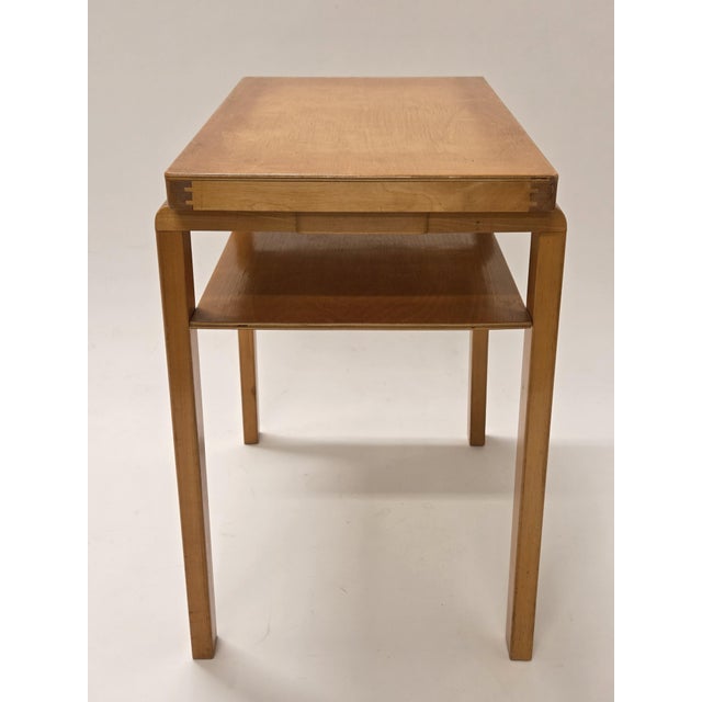 Artek two-tier side table, with old finger-jointed legs from the shortage period, designed by Alvar Aalto. The table is...