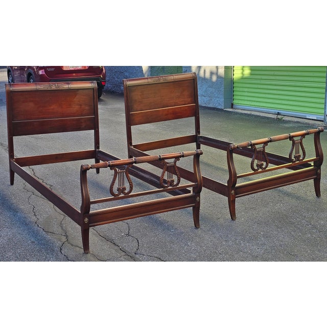 A Rare Pair of Kindel Furniture Oxford Mahogany Lyre Twin Size Bedframes, Circa 1940s. Overall measurements with 39" in...