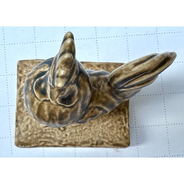 Here we have a rookwood rooster paperweight in there famous blue over tan glaze , designed by McDonal (initials on side...