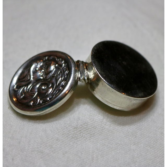 Gorgeous sterling silver snuff or pill box with an art nouveau design of a women sniffing a flower. I love the detailed...
