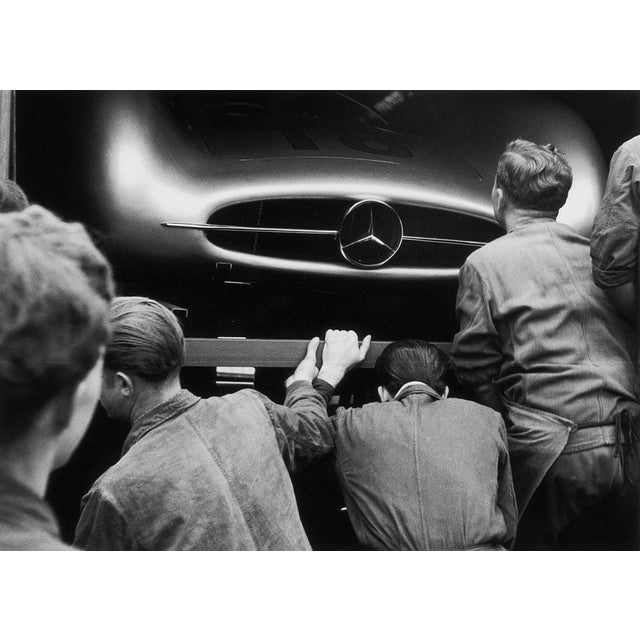 Mercedes Inspection 4th July 1954: Mechanics examine Juan Manuel Fangio's W196 Mercedes Benz in the pits at the French...