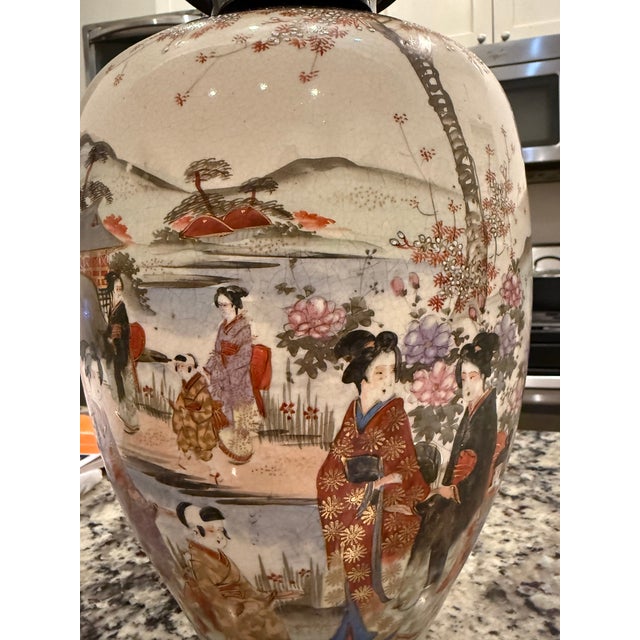 This vase appears to be a Satsuma-style porcelain piece from Japan, likely dating to the late Meiji period (1868-1912) or...