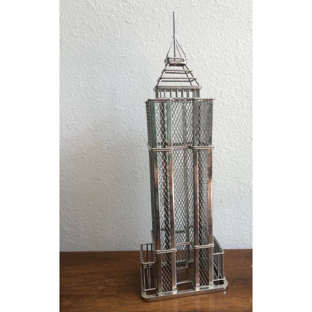 Wire sculpture of the iconic Empire State Building, a landmark in New York City. This piece is perfect for collectors of...