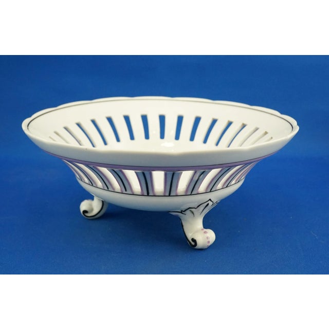 Item description: A stunning three-legged centerpiece, a fruit bowl made of openwork porcelain and entirely decorated by...