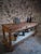 Antique French draper’s table dating from circa 1920–1940, constructed from poplar and pine with a fruitwood top....