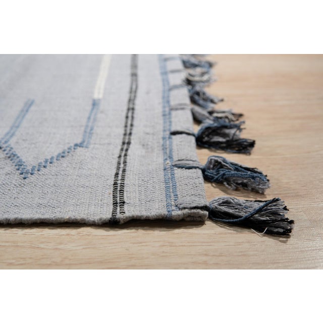 Rustic Penelope Silver Flatweave Rug, Country of Origin: India. This contemporary flatweave piece offers a striking...