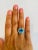This beautiful Cushion Cut Blue Topaz and Diamond ring has a stunningly vibrant Blue Topaz that weighs 3.97 Carats. It is...